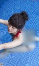 A woman in a red bikini floating in a pool.